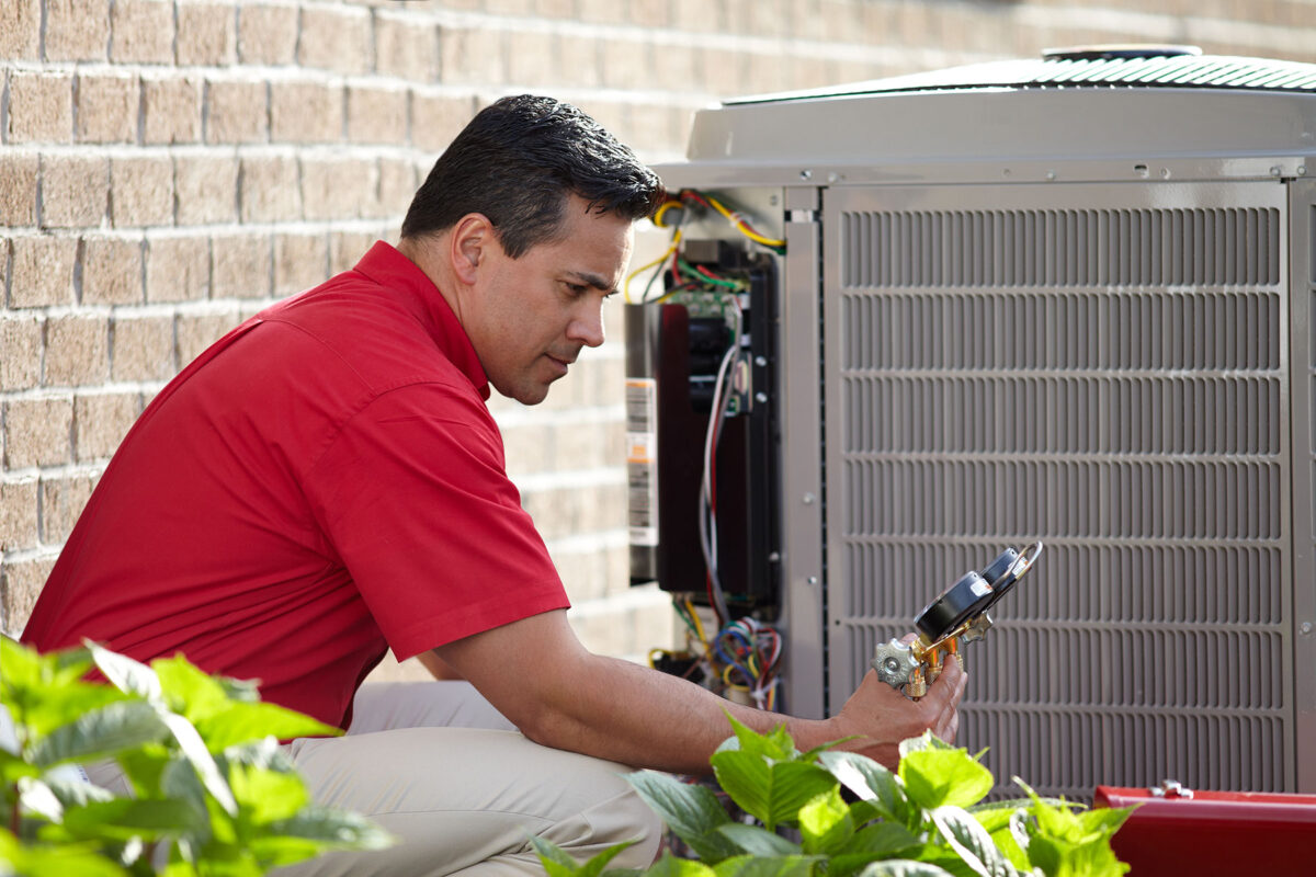 Bryant Heating and Cooling Technician performing HVAC maintenance